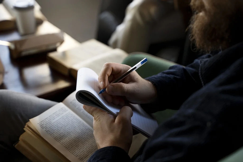 a person writing in a notebook