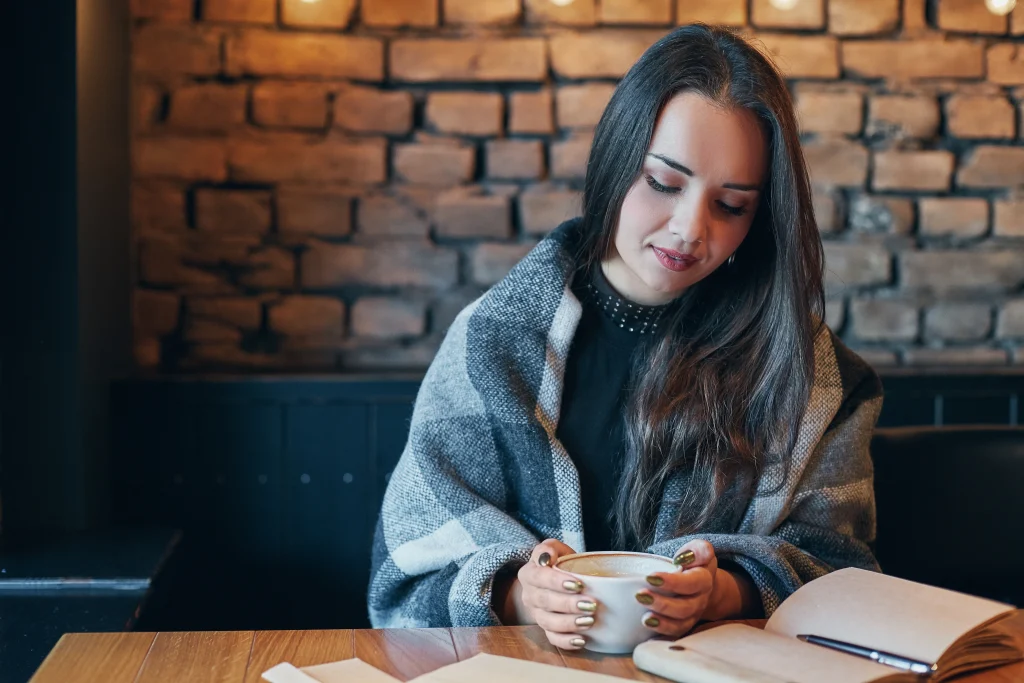 holding a white mug with both hands