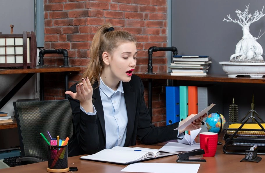 Woman writing notes while planning a speech with the rule of three technique.